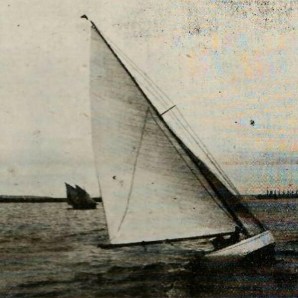 B&W image of a Six Metre boat sailing on water