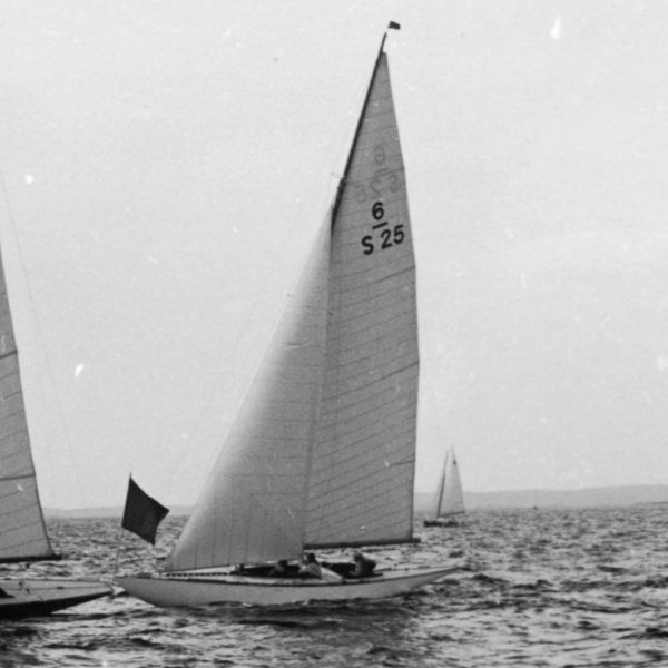 Black and white photograph of Six Metre sailing boat with the number S25 on its sail.