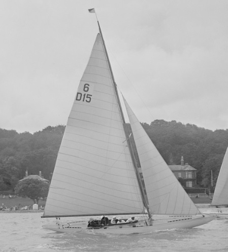 B& W phtoto of a six metre boat sailing on water.