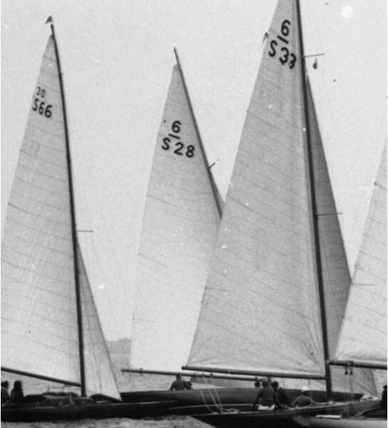 Aloha III (S28) sailing in the back of the black and white image surrounded by three other boats.