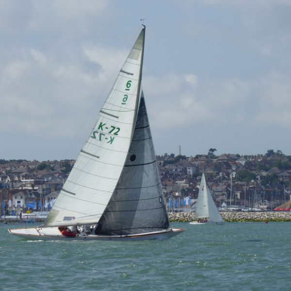 Colour photograph of a Six Metre boat sailing on water