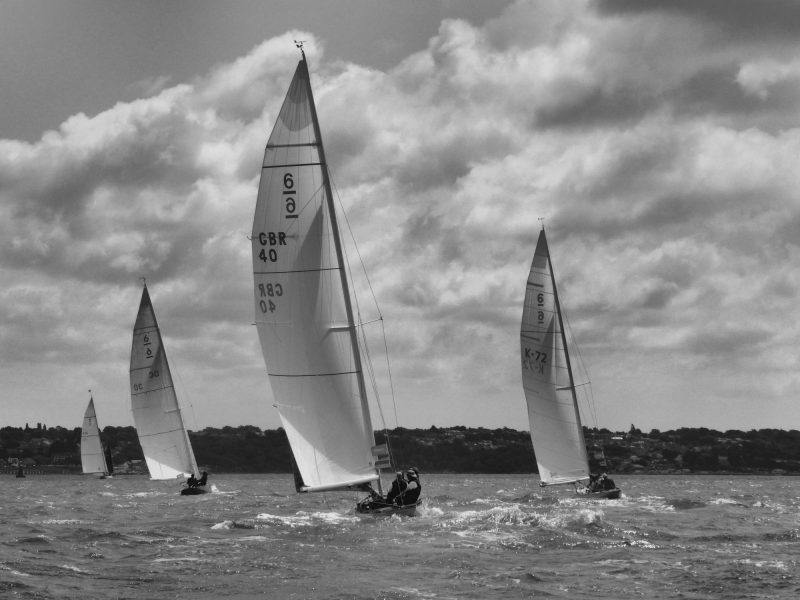Black and white photo of boats racing