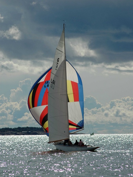 Sailing boat underway with colourful spinnaker sail