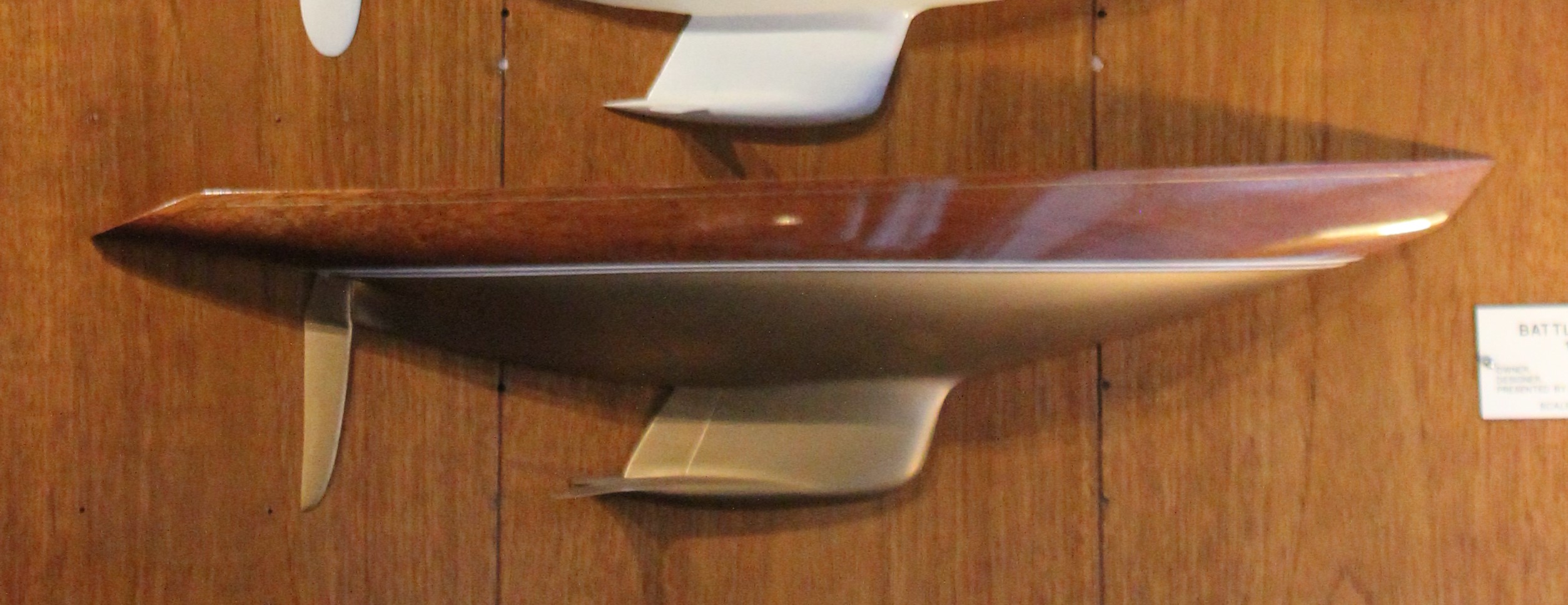 Boat model mounted on a wooden wall