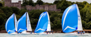 Racing boats with blue sails