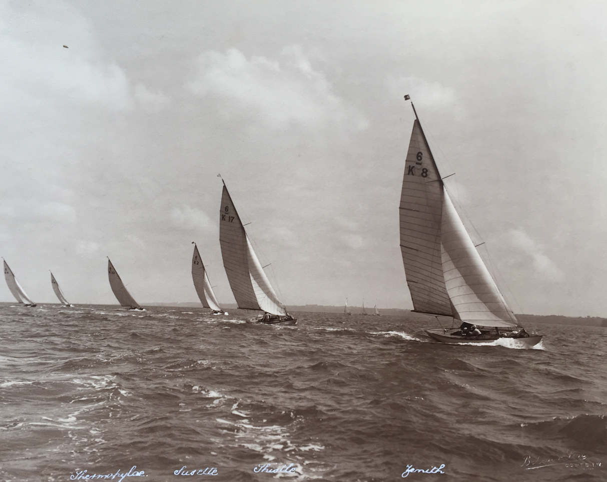 Black and white photograph of 6 sailing boats racing.