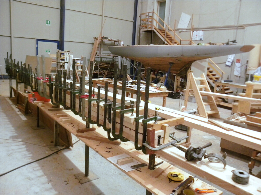 The hull of a boat during restoration and new spars clamped