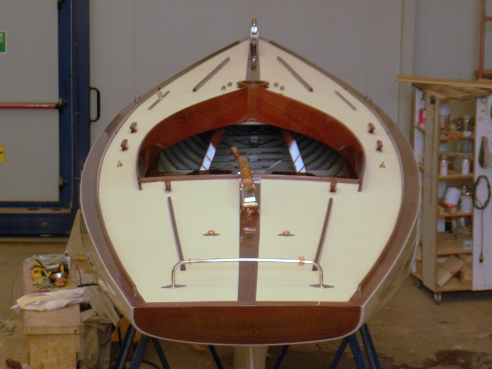 The hull of a boat in a workshop after restoration