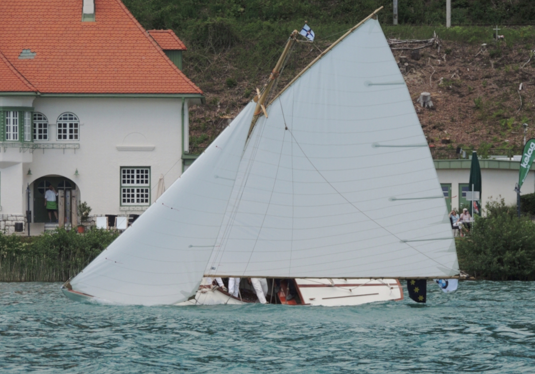 boat sailing in front of a house