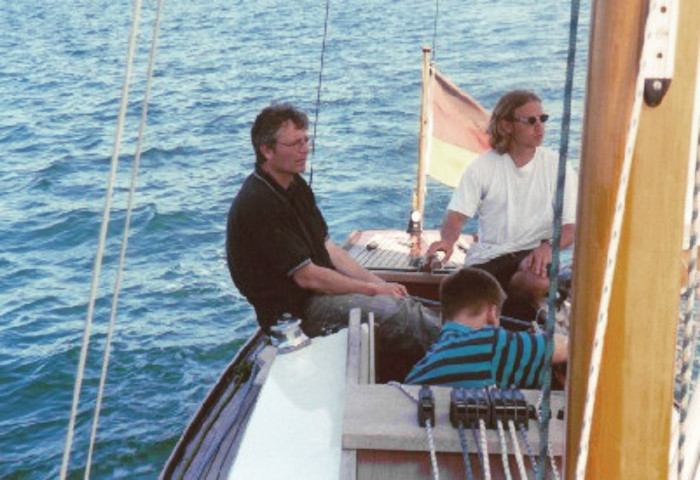 Two men sitting on the deck of a yacht