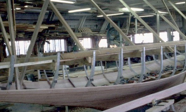 A yacht's hull in the workshop being reconstructed