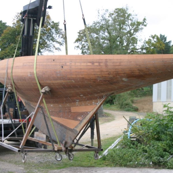 a hull with bare wood on a cradle