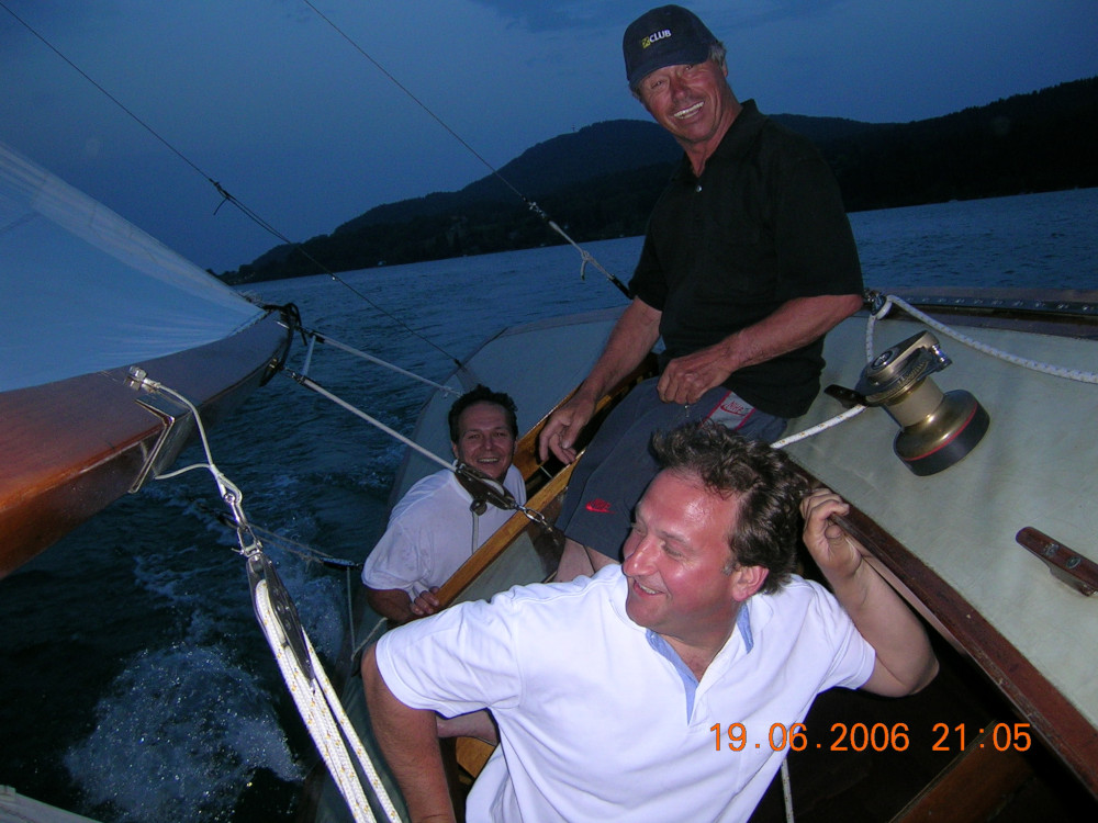 three crew on a yacht in the evening