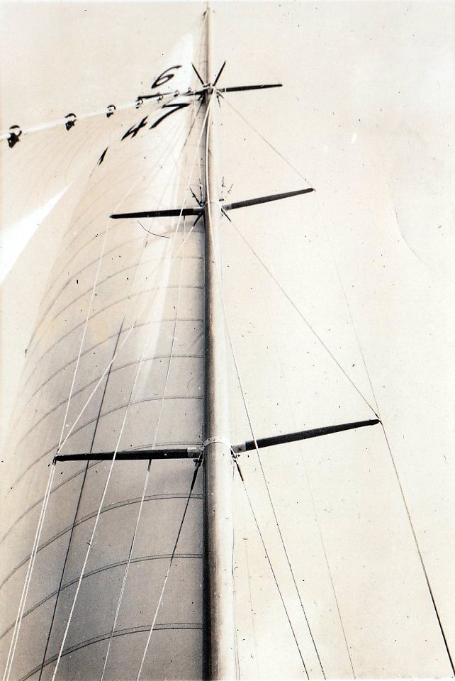Black and white photograph of a Six Metre sailing boat's mast and sails, viewed from the deck.