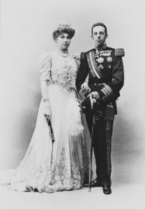 Photograph of a full length portrait of King Alfonso XIII (1886-1941) and Queen Victoria Eugenie (1887-1969), in court dress