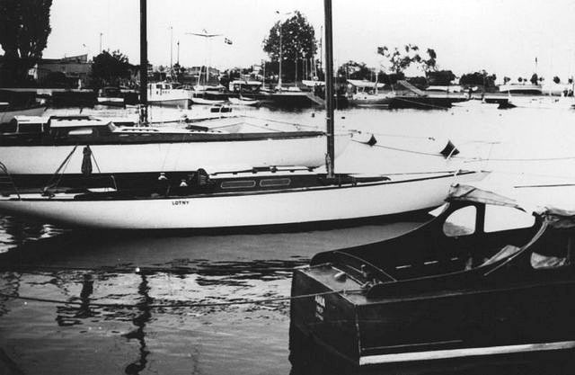 black and white photo of the hull of a yacht, moored