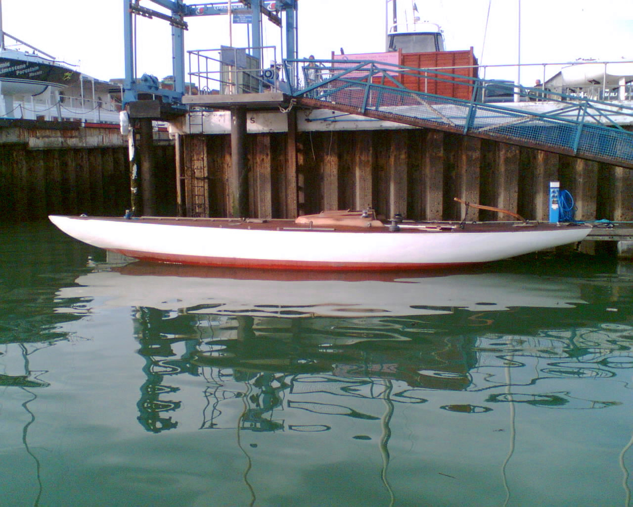 A red and white yacht hull moored