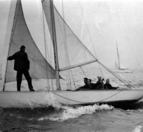 black and white photo of a white yacht sailing