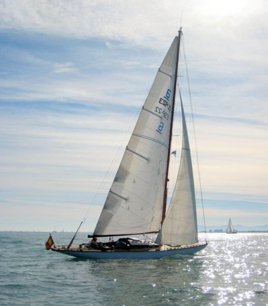 A colour photo of a yacht sailing in blue waters