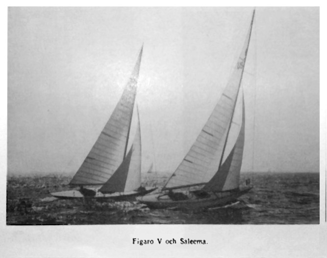 Black and white photo of a pair of white sailed yachts sailing