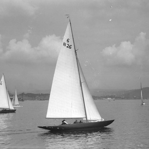 Black and white photo of a group of yachts sailing on calm waters