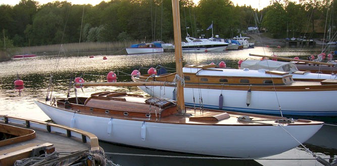 A colour photo of wooden yachts moored