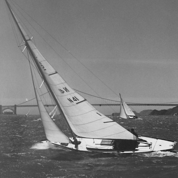 A black and white photo of a yacht sailing