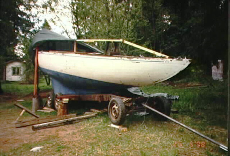 A blue and white yacht hull on a cradle