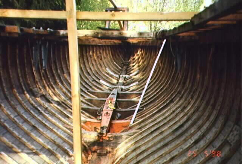 Detail of a wooden hull of a yacht in poor condition.