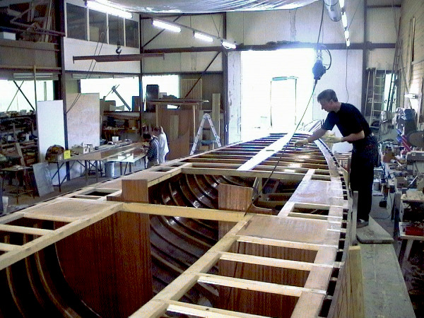 A man is working on the hull deck.