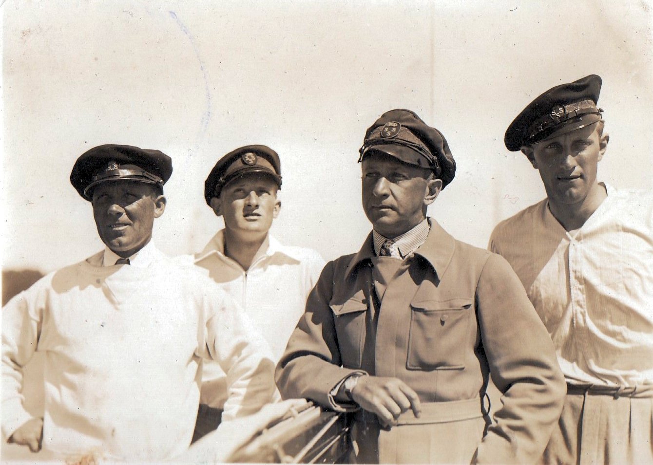 Black and white photograph of four men, the crew of Six Metre boat KSSS 1933.