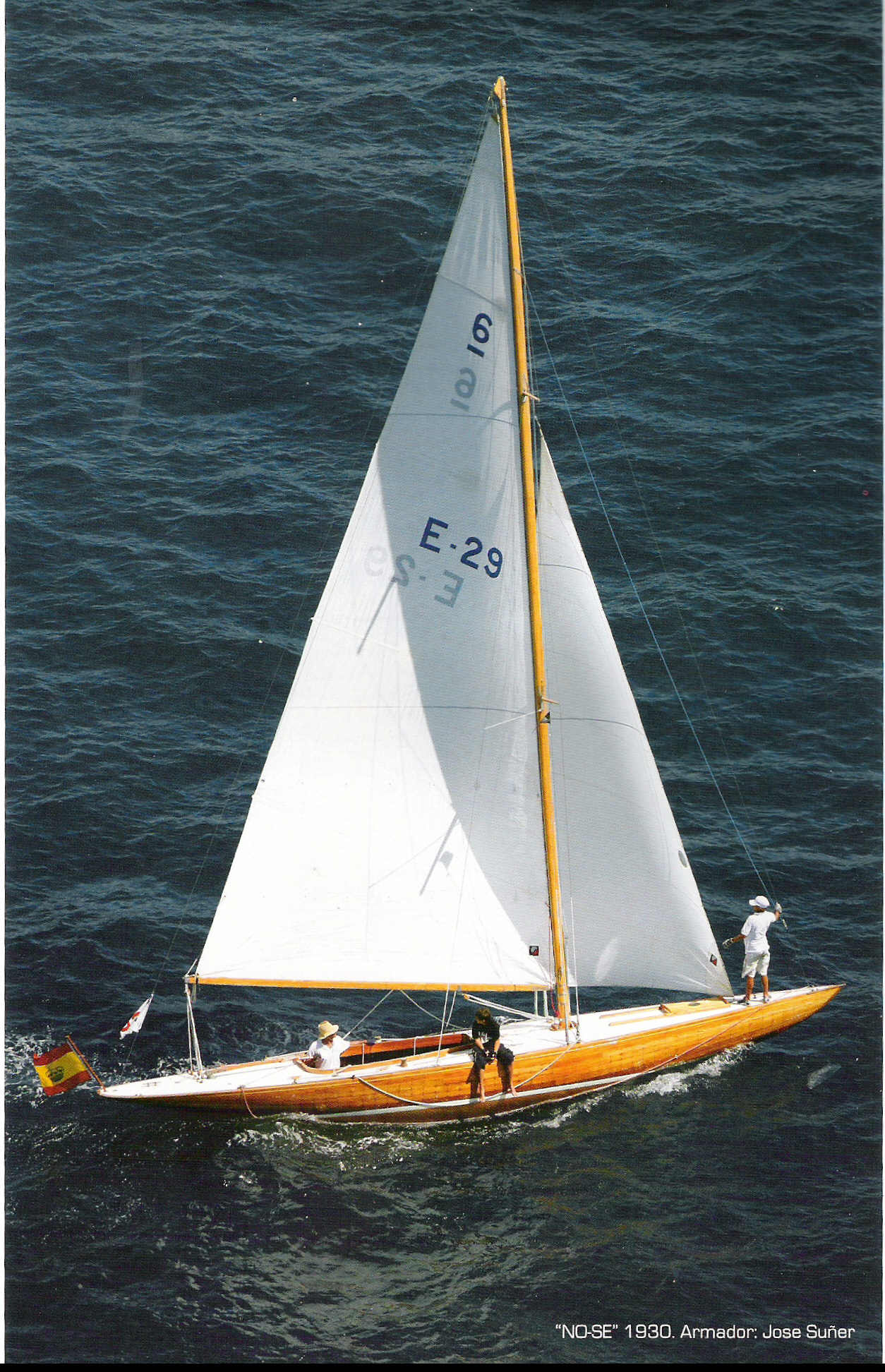 Polished wooden hull with a white sail.
