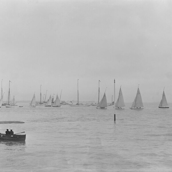 Six Metre boats and rowing boats sailing on water