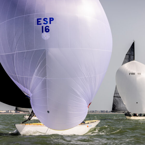 Six Metre boats sailing on water with spinnakers raised